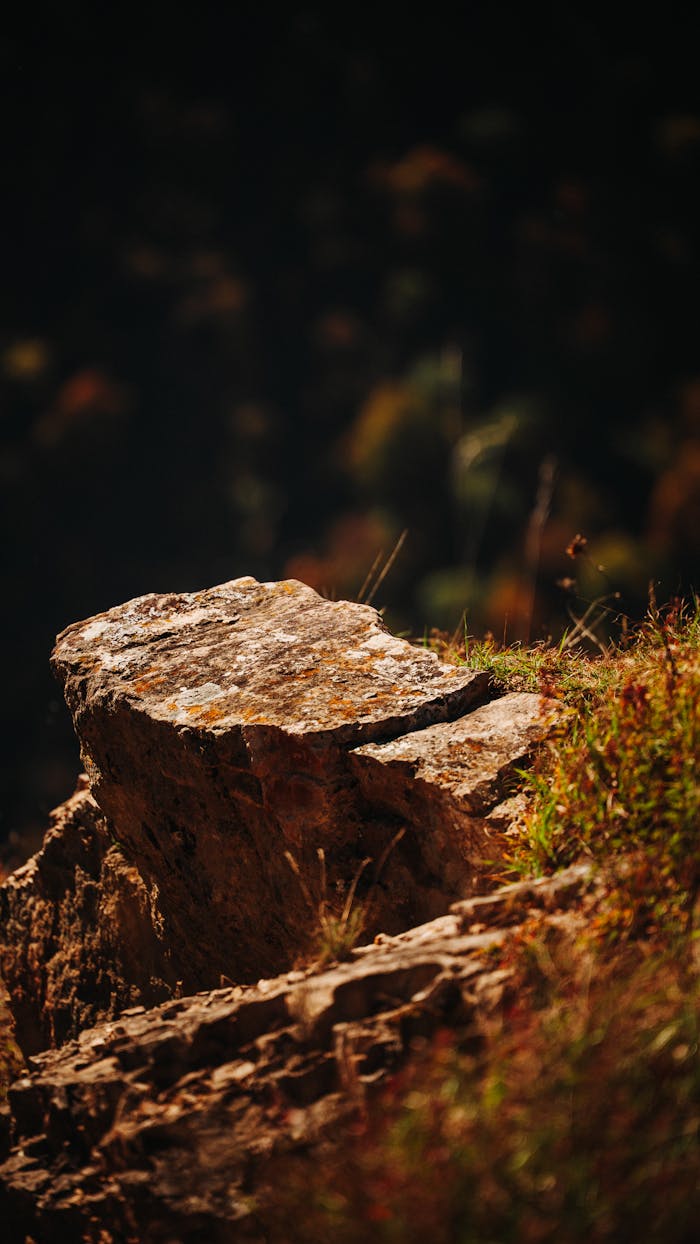 Warm and earthy rocky outcrop illuminated by sunlight, capturing nature's rugged beauty.